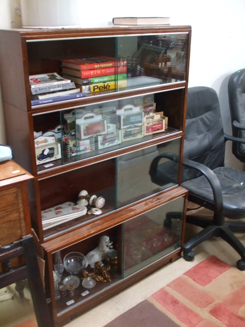 A 1950s Glazed Mahogany Bookcase with sliding doors.