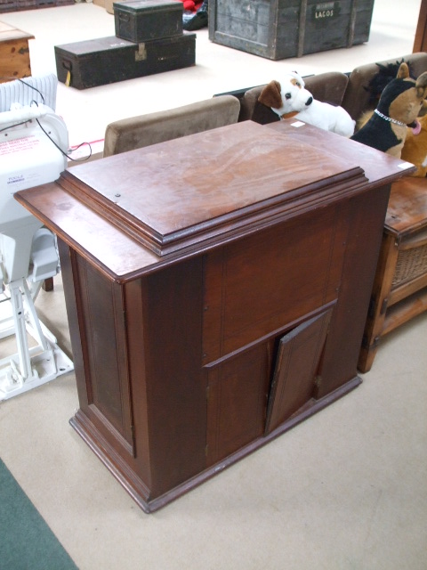 A Treadle Sewing Machine, with interior fitted machine intact