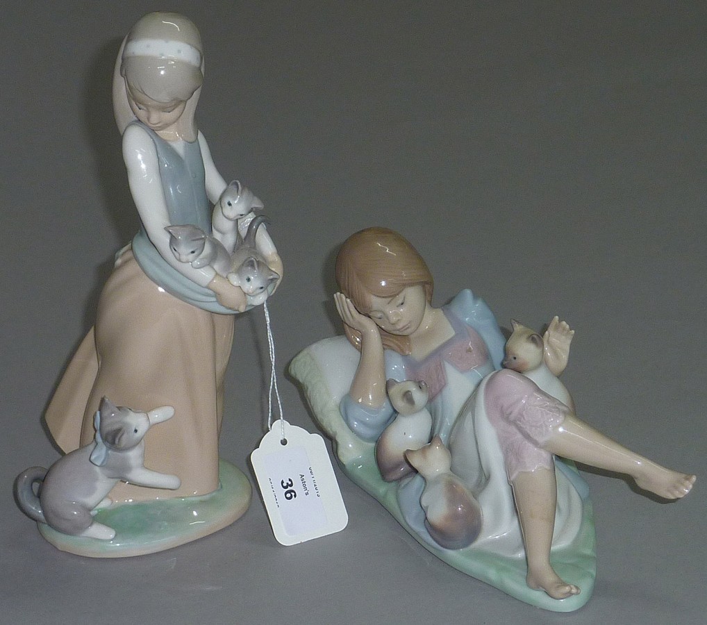 Two Lladro figures of girls with kittens.