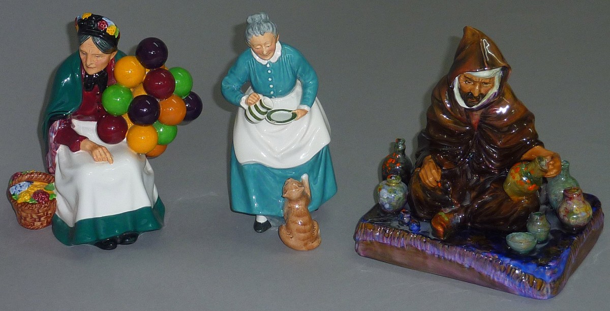 Royal Doulton `The Potter`, marked `HN 1493`, together with `The Old Balloon Seller`, HN 1315 and `