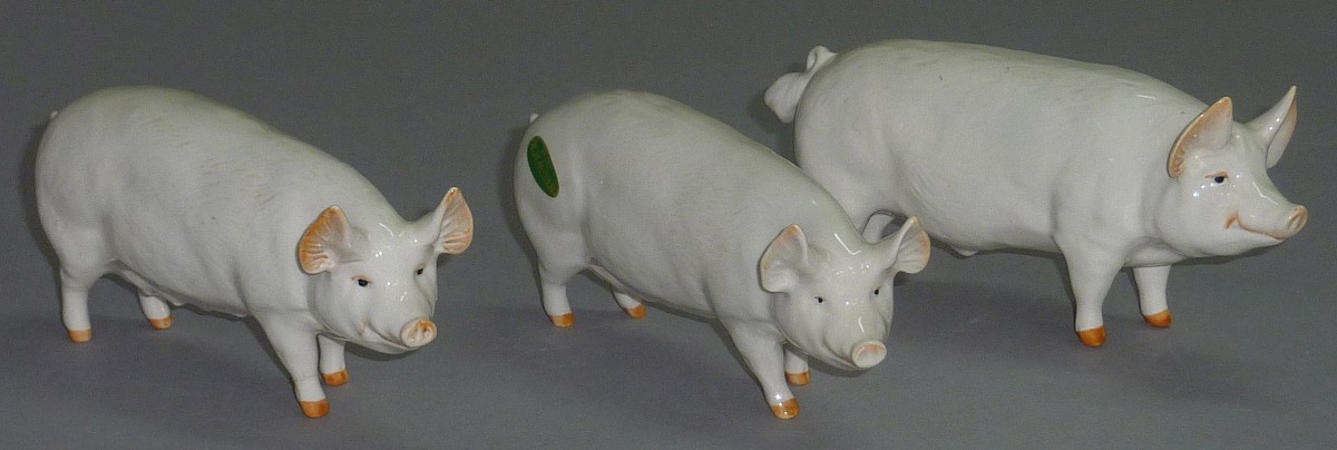 Three Beswick pigs.