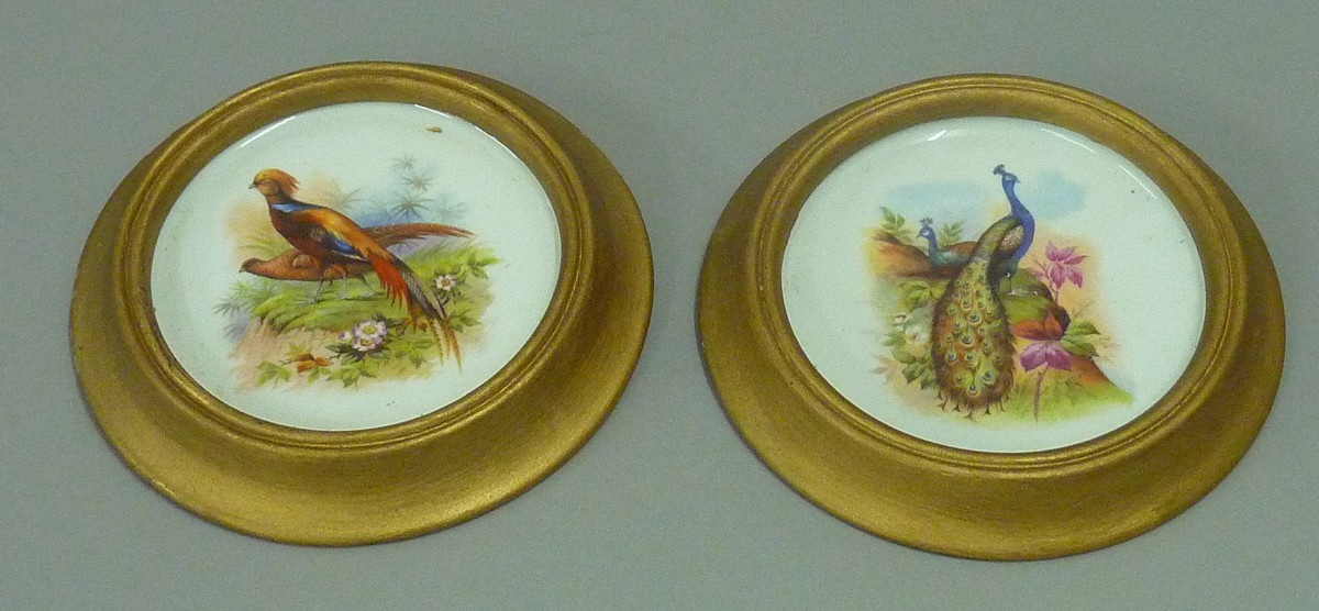 Pair of enamelled porcelain wall plaques. Diameter 19.5cm.