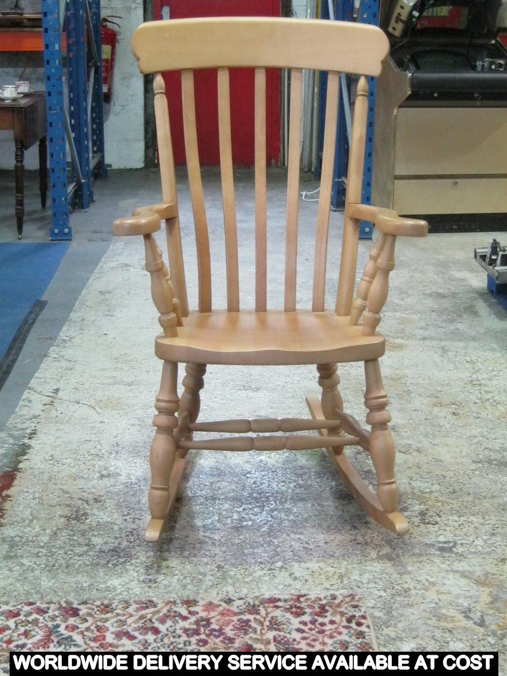 A beechwood Windsor elbow rocking chair