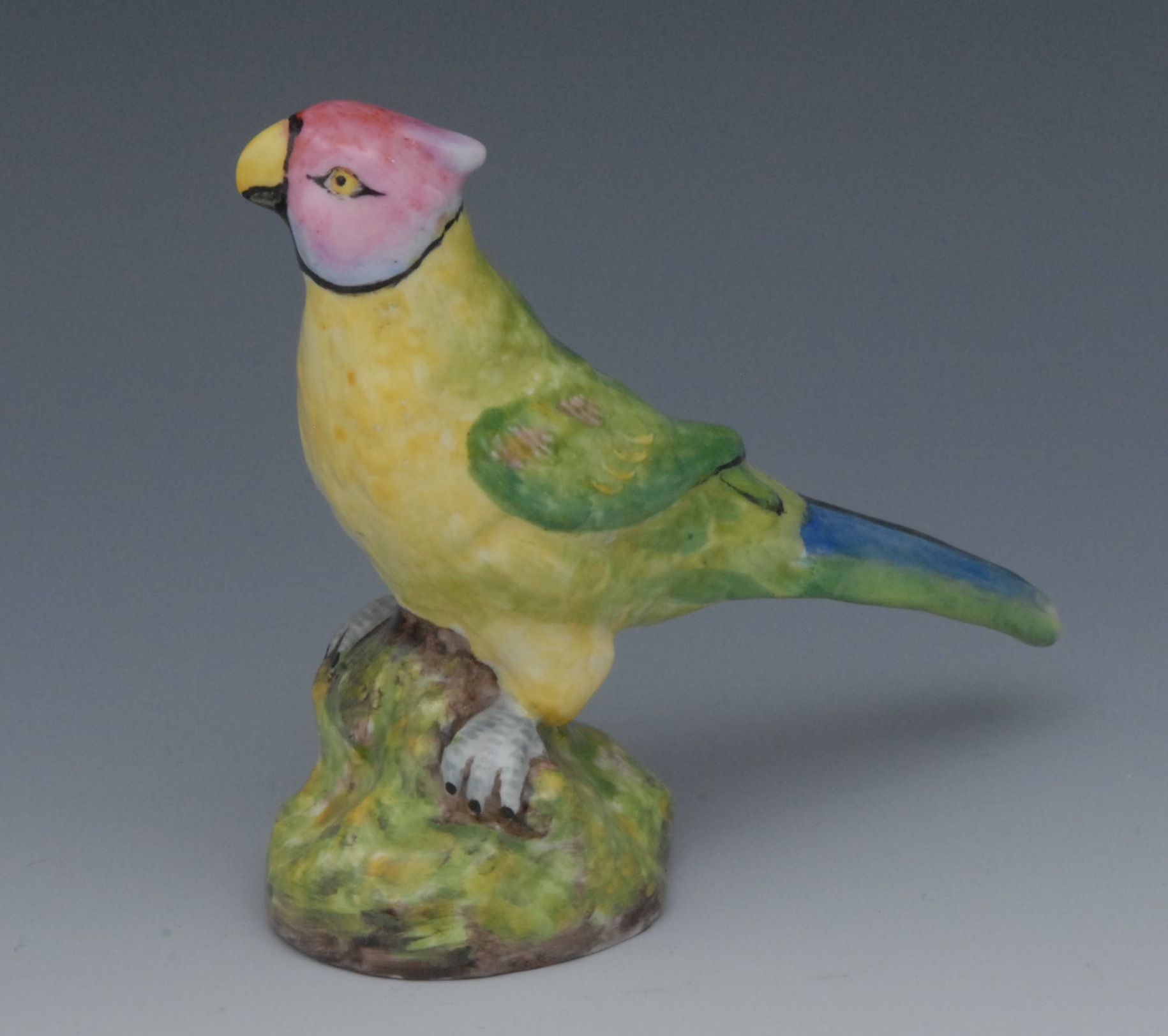 A Sampson Hancock parrot, brightly enamelled, perched on a mound, 11.25cm high, S, H, crown, crossed