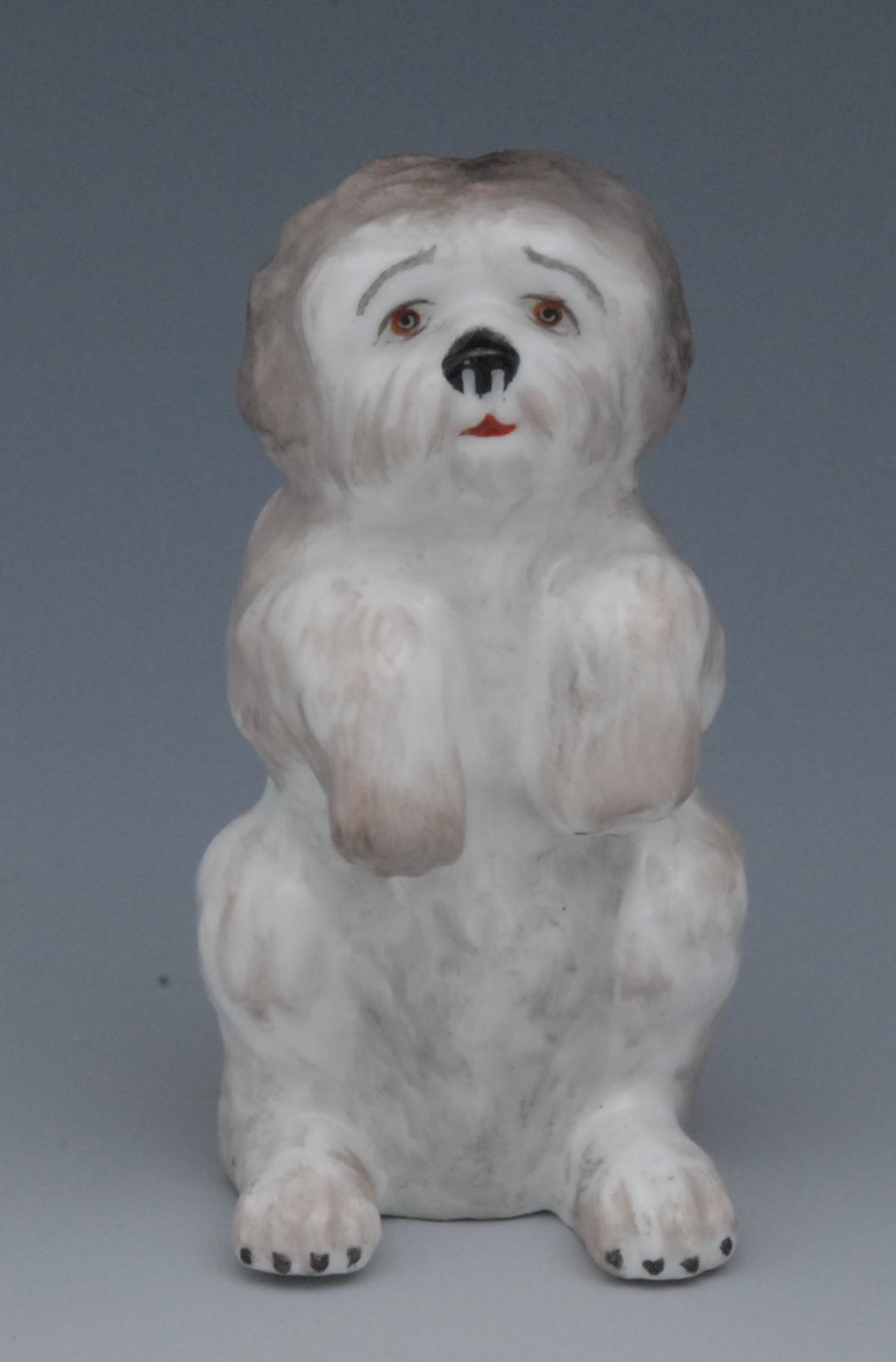 A Sampson Hancock model, Shih Tzu, begging, coloured in tones of brown, 6.5cm high, S, H, crown,