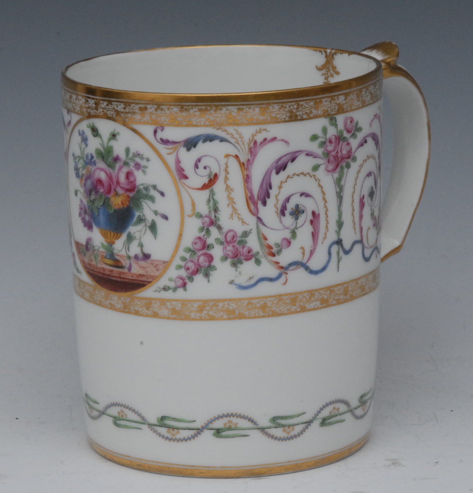 A French mug, well painted with jardiniere of flowers and foliage, within a circular cartouche,