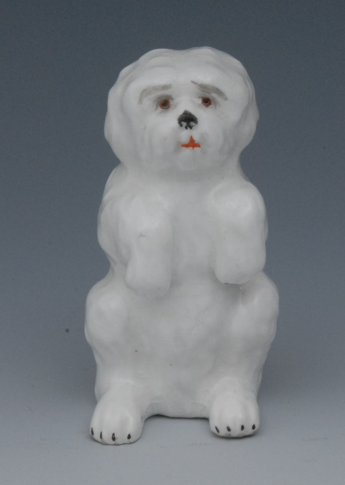 A Sampson Hancock model, Shih Tzu, begging, lightly coloured, 6.5cm high, S, H, crown, crossed