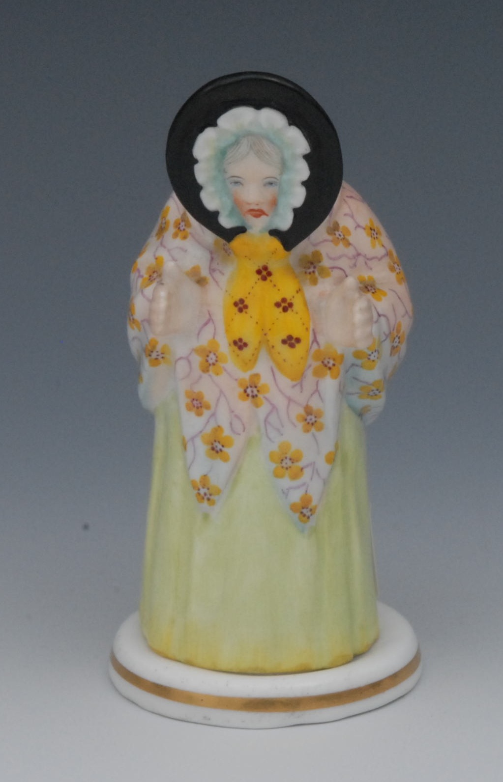 A Sampson Hancock novelty candle snuffer, Sarah Gamp, she stands wearing a black bonnet, floral