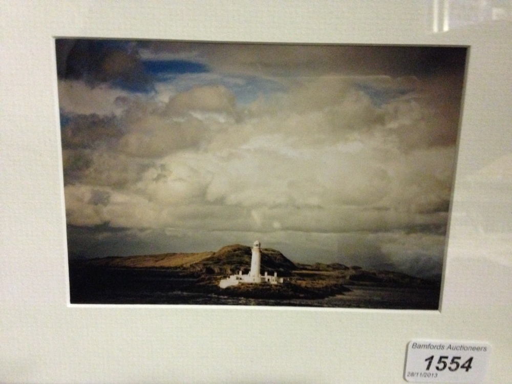 Donated by Toby Neal, a framed photographic print of a lighthouse