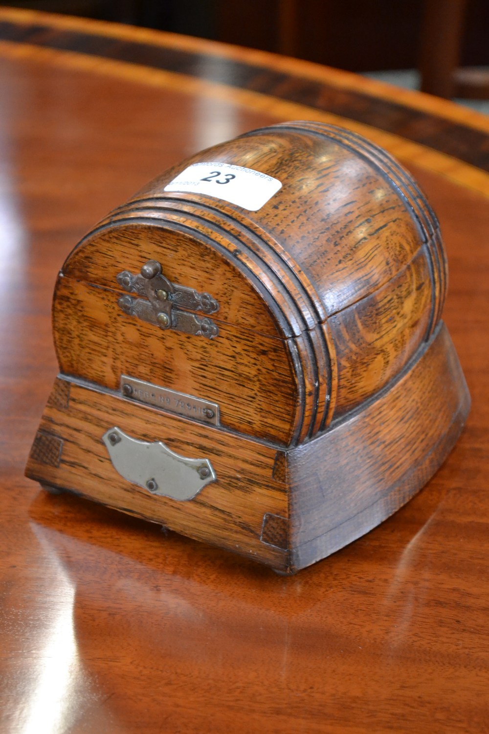 An early 20th century oak musical barrel shaped casket, Swiss mechanism, reg.no.72941, c.1925