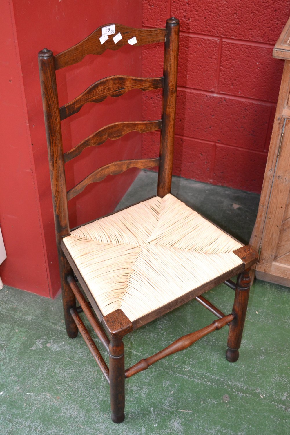A lath back back country kitchen chair with rush seating, and another