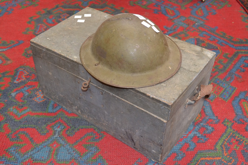 A pine box and a British military helmet