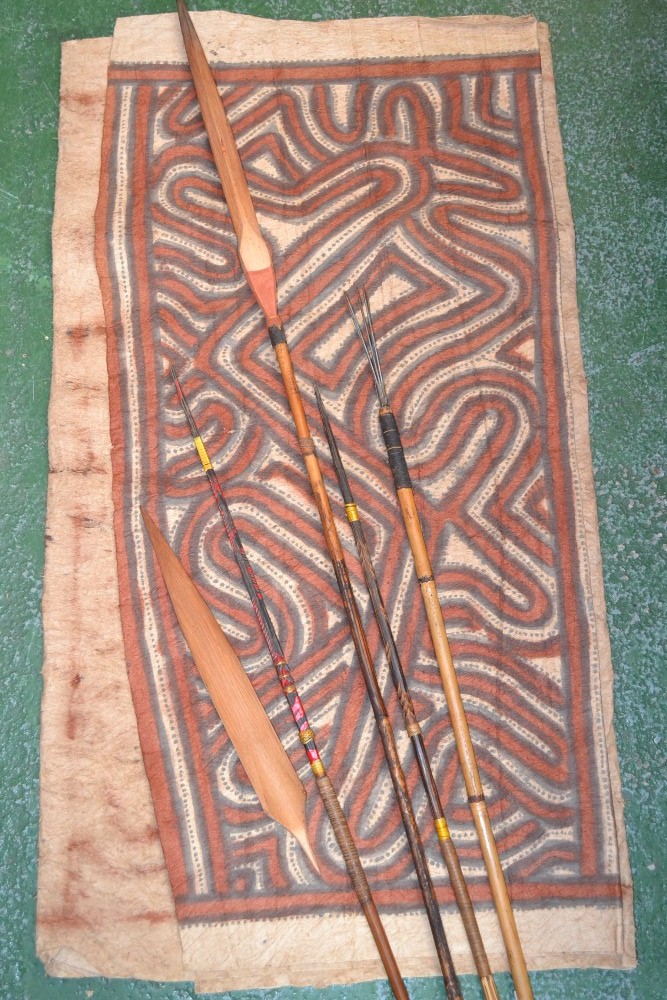 Tribal art - Papua New Guinea, four spears; a spear head; a painted skin mat (6)