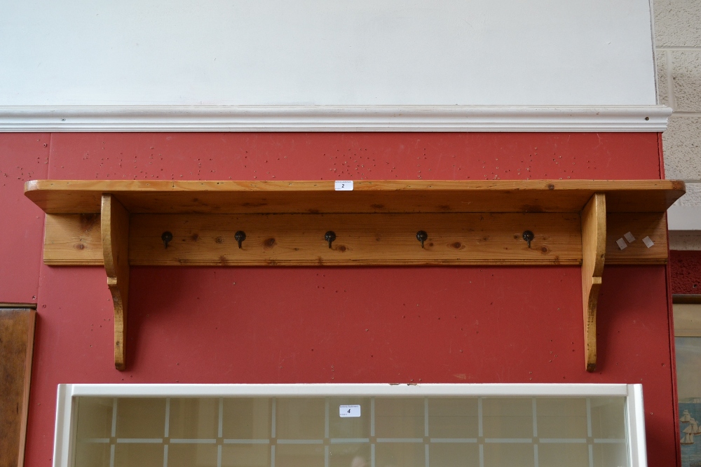 A wall mounted pine coat rack