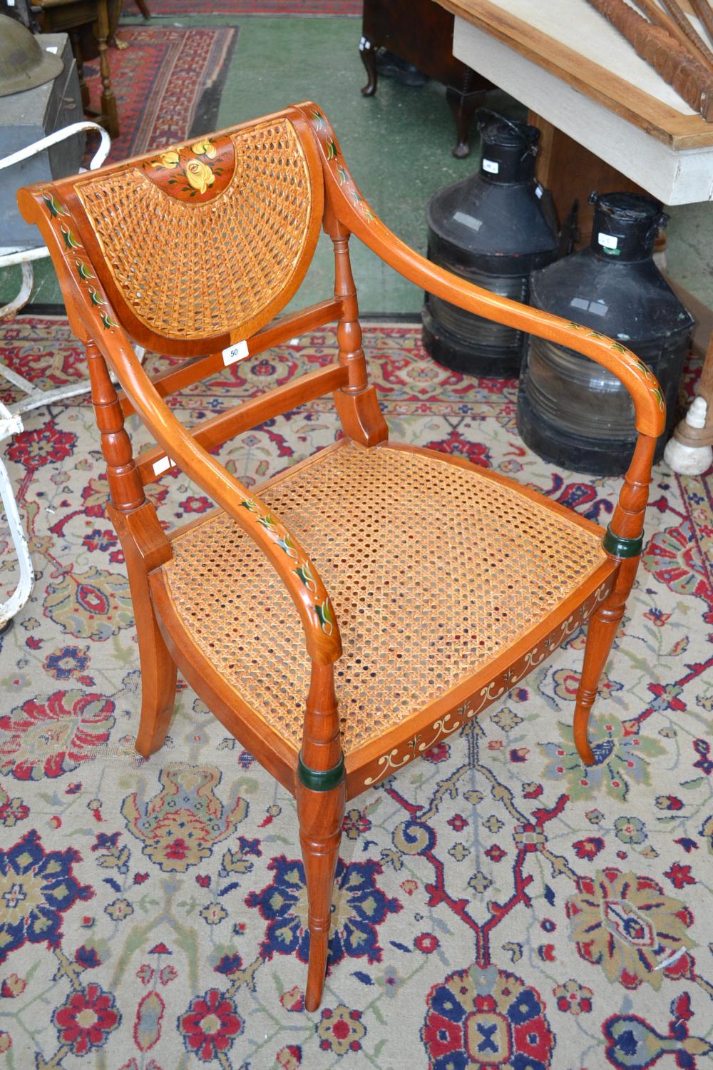 A 1930`s reproduction open armchair, painted, cane seating