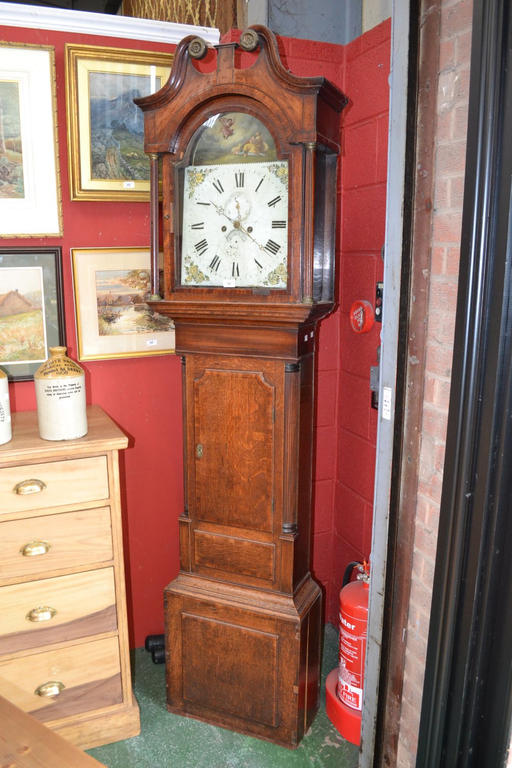 A William IV oak and mahogany longcase clock, 33cm arched painted dial with Roman numerals, the arch