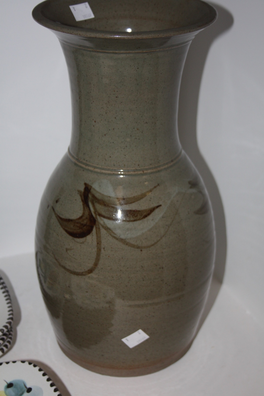 A mid 20th century studio pottery vase, in the St Ives style with flared top and ridged neck, marked