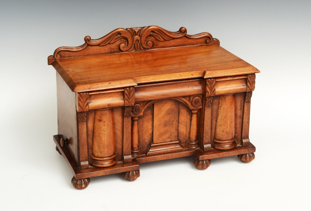 A rare William IV mahogany novelty tea caddy, shaped back carved with acanthus scrolls, hinged cover