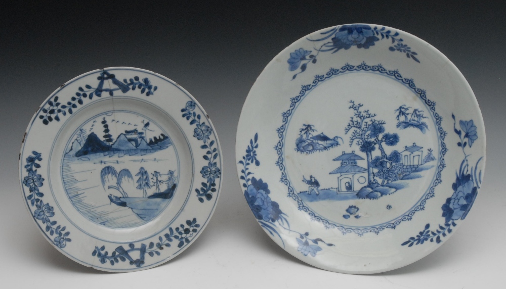 A Chinese circular dished plate, painted in underglaze blue with pagoda, pine tree and figure, the