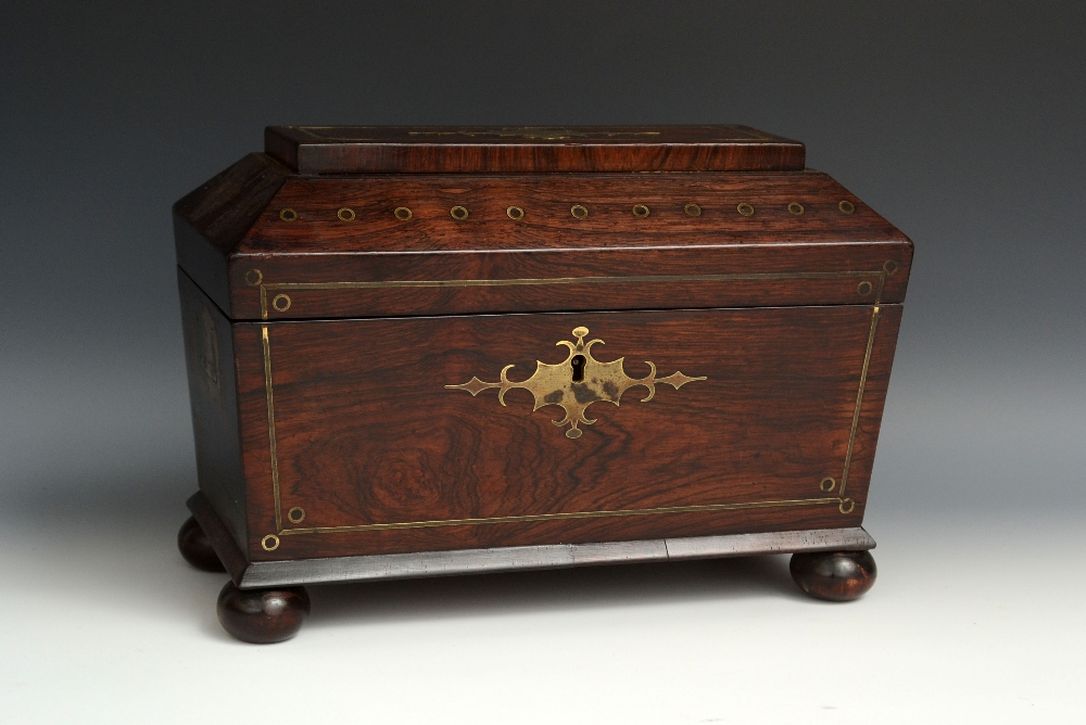 A Regency rosewood and brass marquetry sarcophagus tea caddy, hinged cover lined to verso with