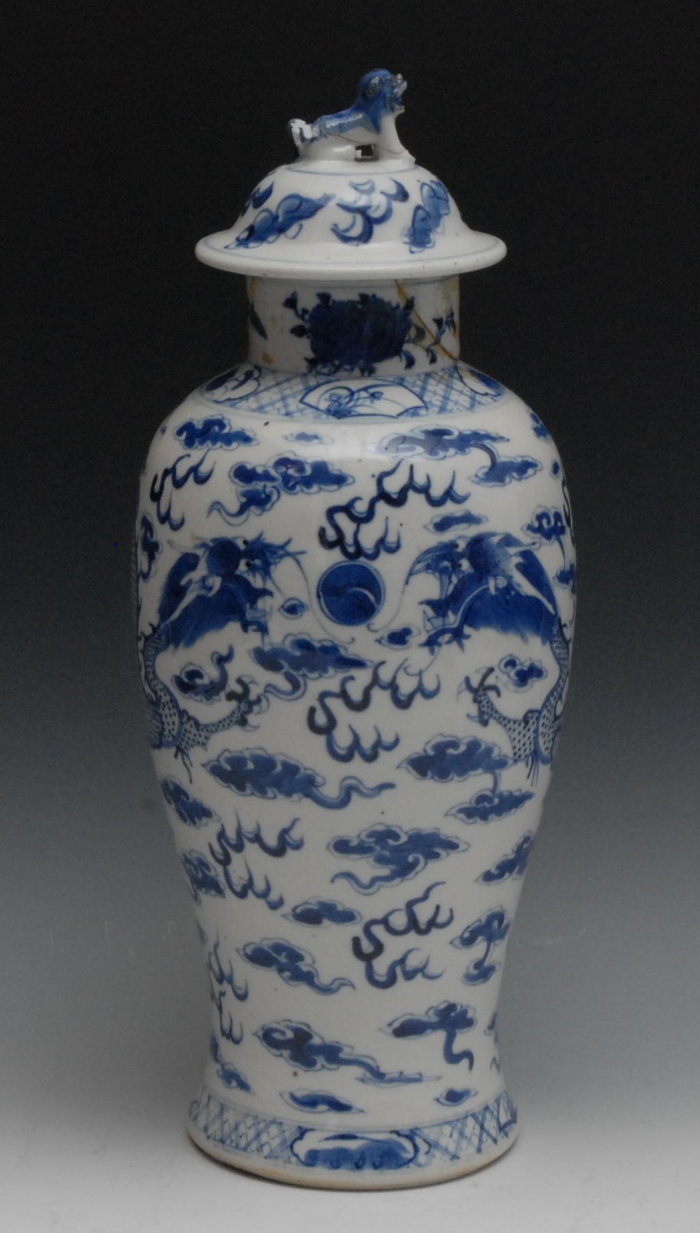 A 19th century Chinese baluster vase and cover, painted in underglaze blue with dragons chasing