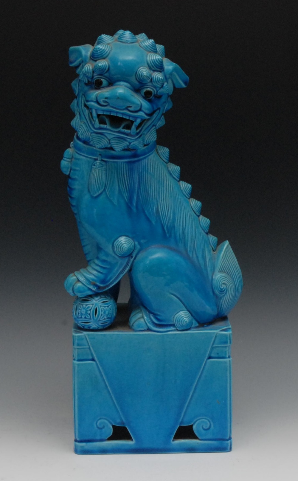 A Chinese turquoise Dog of Fo, his paw on a ball, on pedestal, 40cm high, 20th century