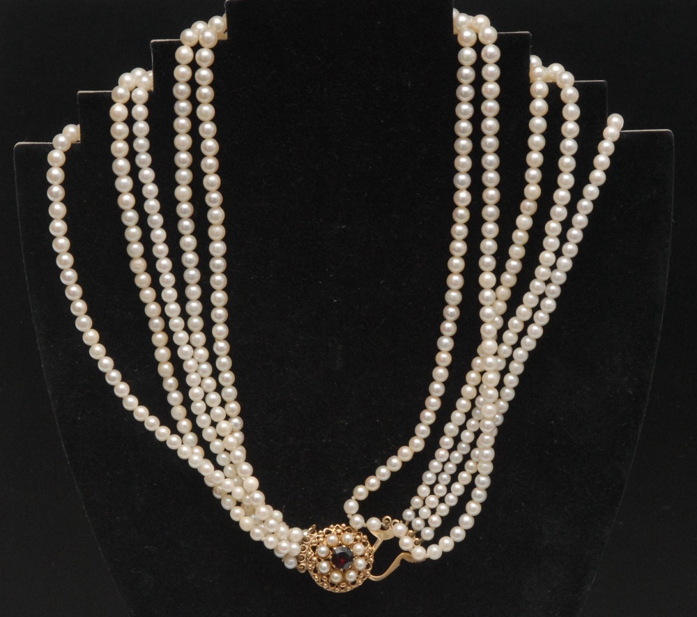 A cultured pearl five row necklace, the graduated strands fastened by a 9ct clasp claw set with a