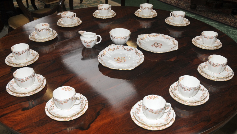 A Royal Crown Derby fluted tea service, for twelve, gilt and red feathered border, printed mark