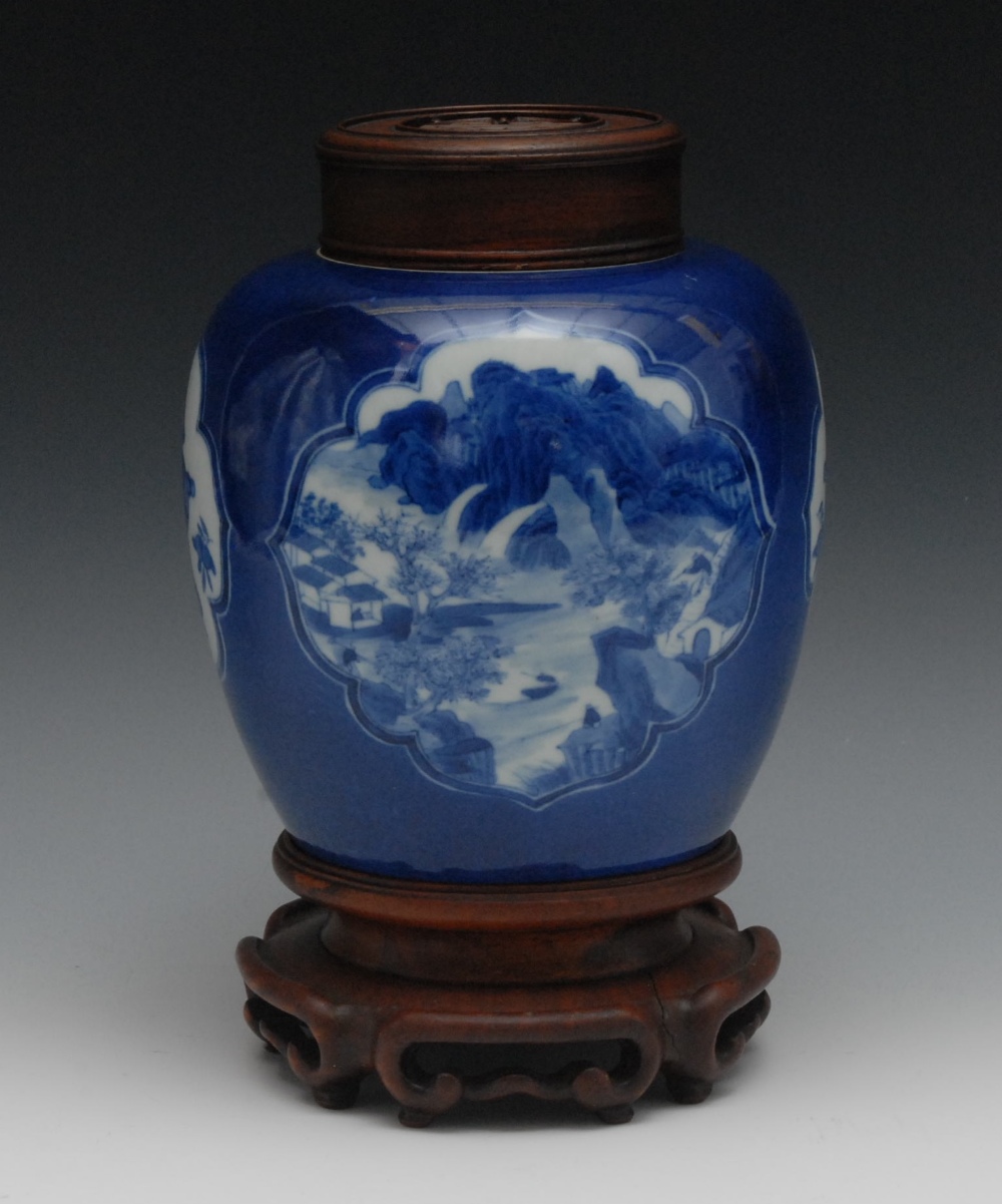 A Chinese ginger jar and cover, painted in underglaze blue with two large cartouches containing