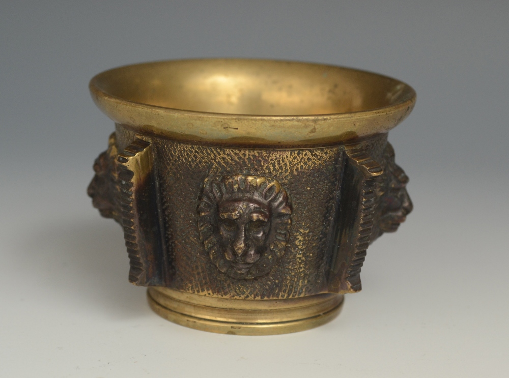 A 19th century dark patinated and polished bronze table vesta, as a mortar, the side cast with