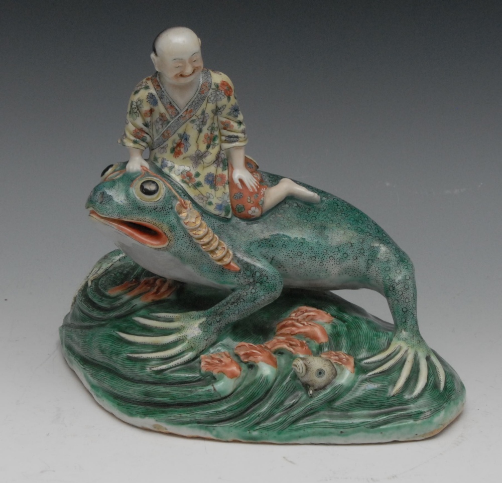 A Chinese stoneware model of Jin Chan the Three Legged Toad, with Liu Hai on his back, in tones of