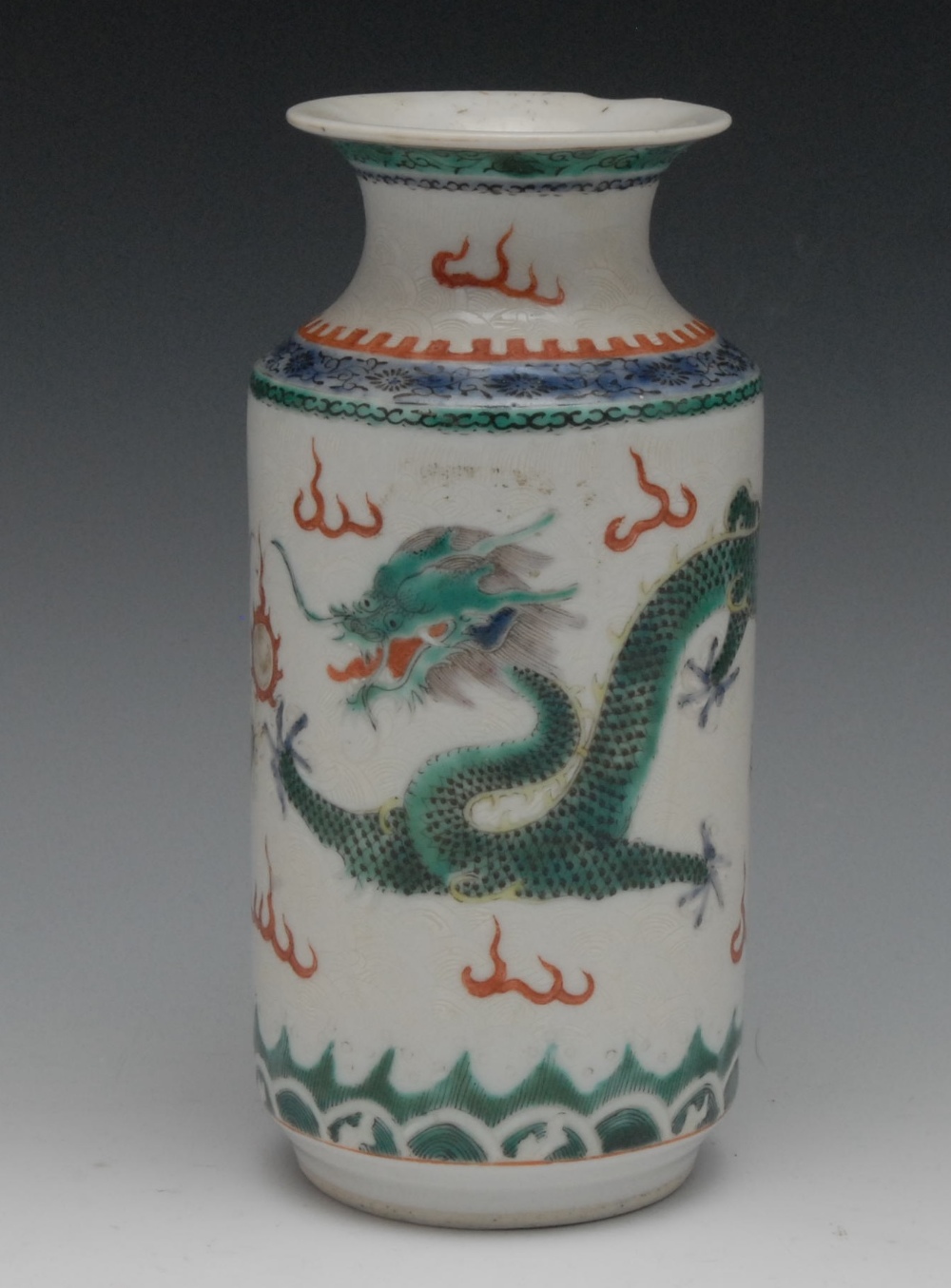 A Chinese wucai sleeve vase, painted with fierce dragons in mutual pursuit of a flaming pearl,