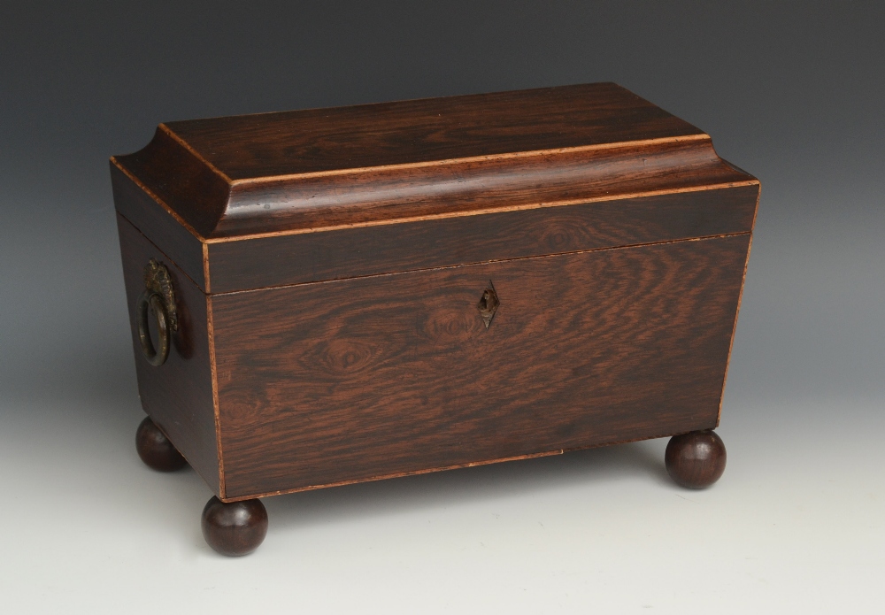 A George III rosewood sarcophagus tea caddy, hinged cover enclosing a cut glass bowl and a pair of