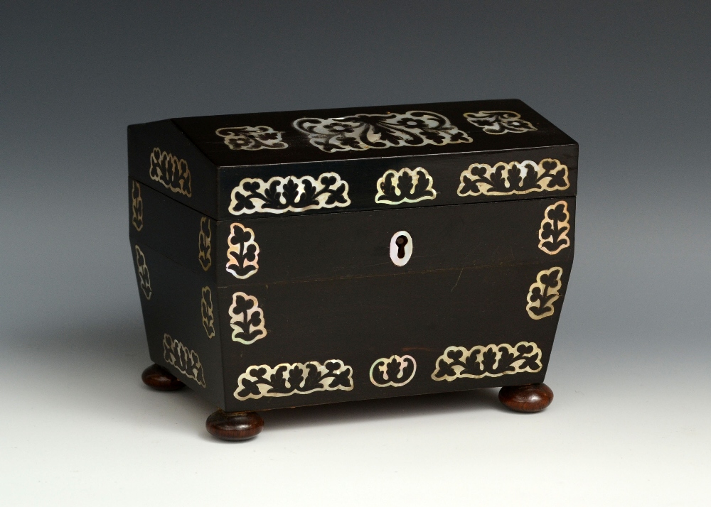 A Victorian mother of pearl marquetry tea caddy, hinged pitched cover enclosing a doubter, inlaid