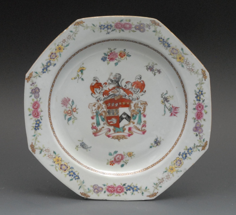 A Chinese Armorial octagonal plate, painted in polychrome with crest, the border with floral