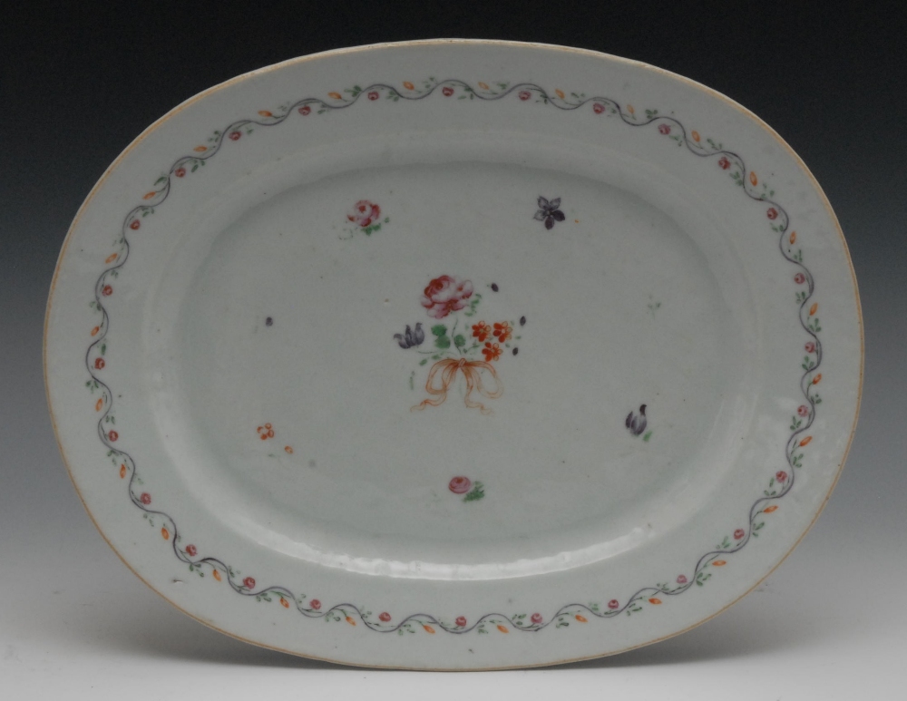 A Chinese rounded rectangular plate, painted in the Famille Rose palette with a ribbon-tied spray