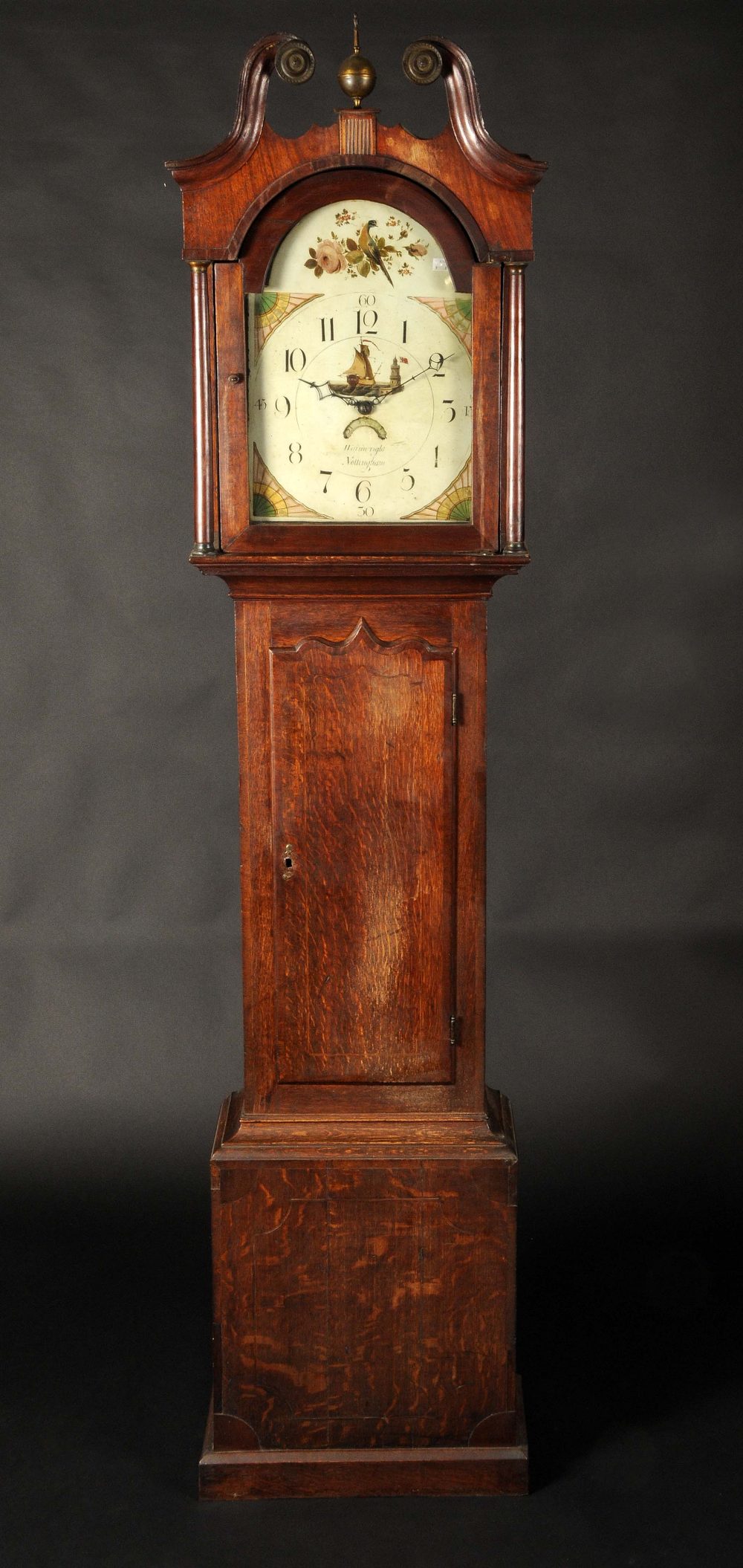 A William IV mahogany crossbanded oak longcase clock, 33cm arched painted dial inscribed Wainwright,