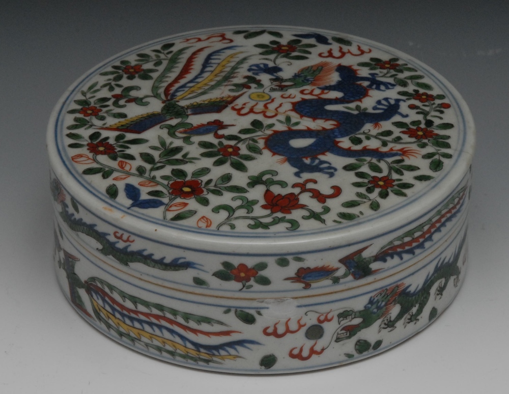 A Chinese circular box and cover, decorated in the wucai palette, with phoenix, dragon chasing the