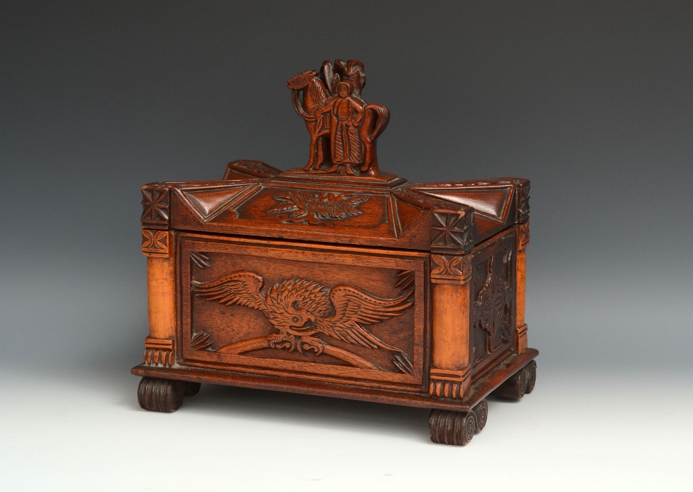 A 19th century American folk art casket tea caddy, lift-off cover surmounted by a finial carved as a