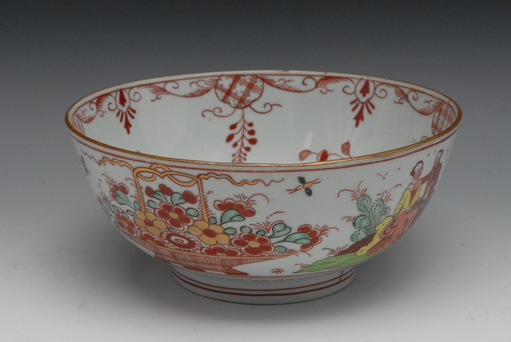 A Chinese porcelain bowl, painted with European figures taking tea, the interior and verso with