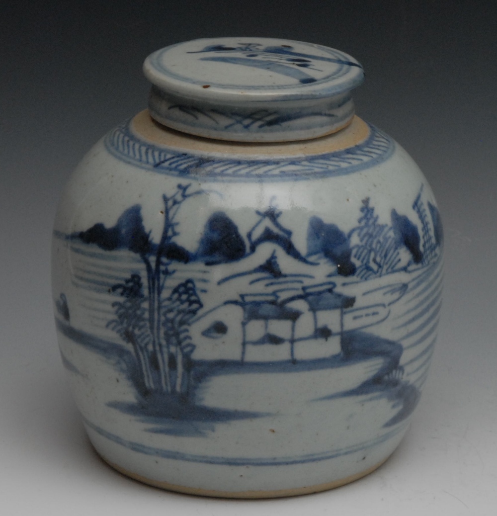 A Chinese blue and white ginger jar and cover, decorated with stylised river scene, 19cm high