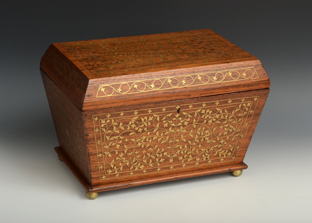 A 19th century Anglo-Indian sarcophagus hardwood and brass tea caddy, hinged cover enclosing a