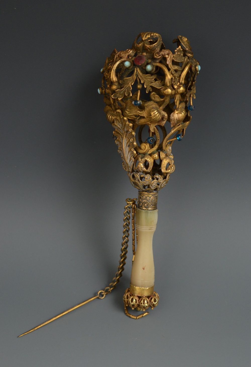 A 19th century gilt metal posy holder, pierced and chased with vine and leafy scrolls, set with