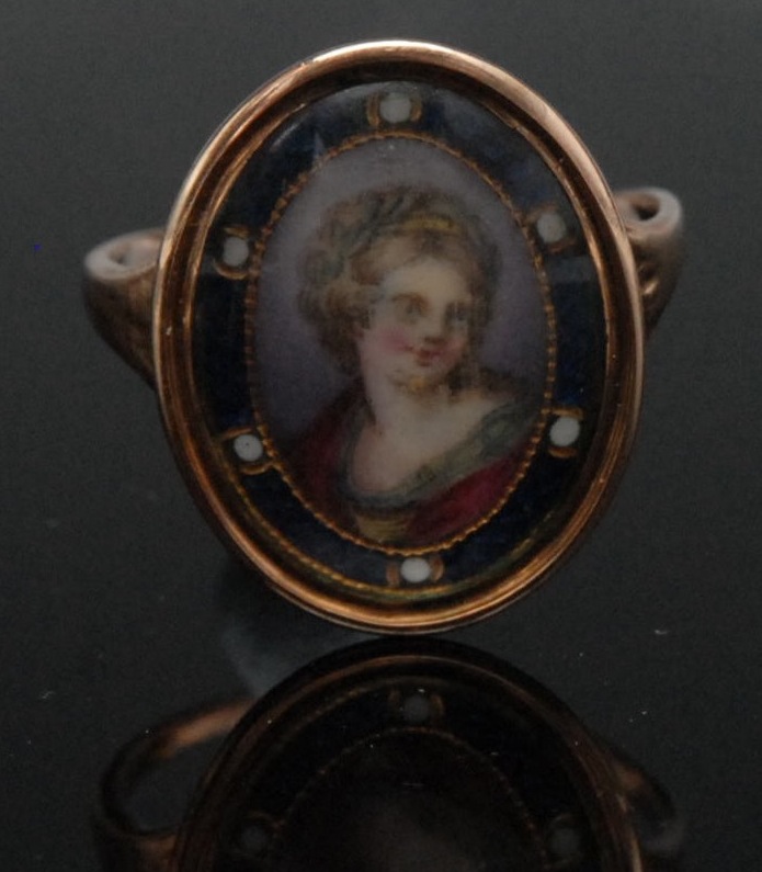 A George III miniature ring, painted with lady, banded blue border, gold mount and shank