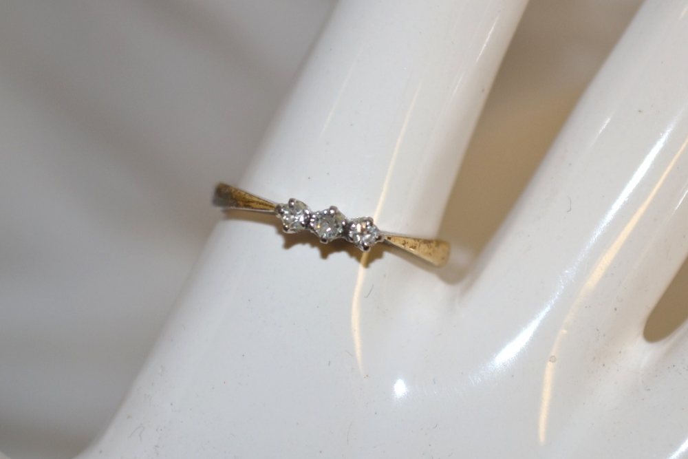An 18ct gold three stone diamond ring, 2g