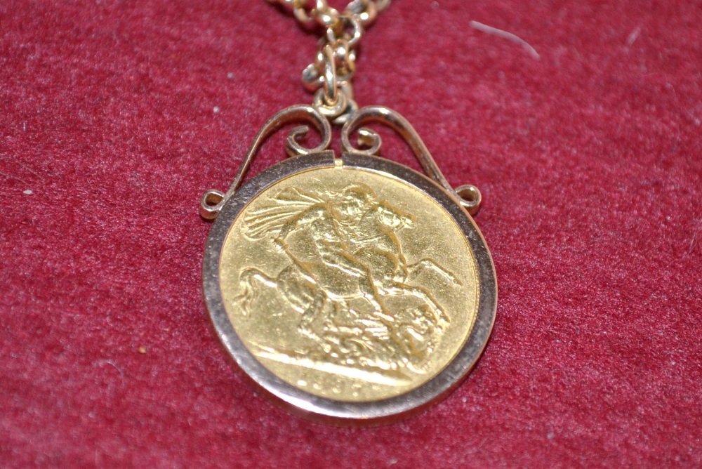 A Victorian full sovereign, c.1887, mounted, and 9ct. gold chain