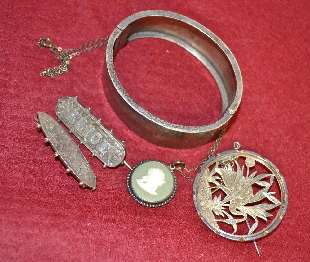 A Victorian Aesthetic Movement hinged bangle, Birmingham 1876; a similar pierced circular brooch