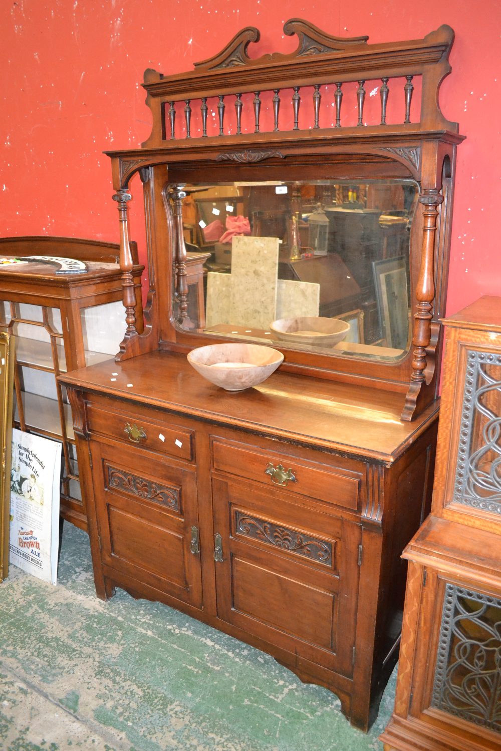 A mahogany mirror back sideboard, carved swan neck pedimont with spindle gallerie, shaped bevelled