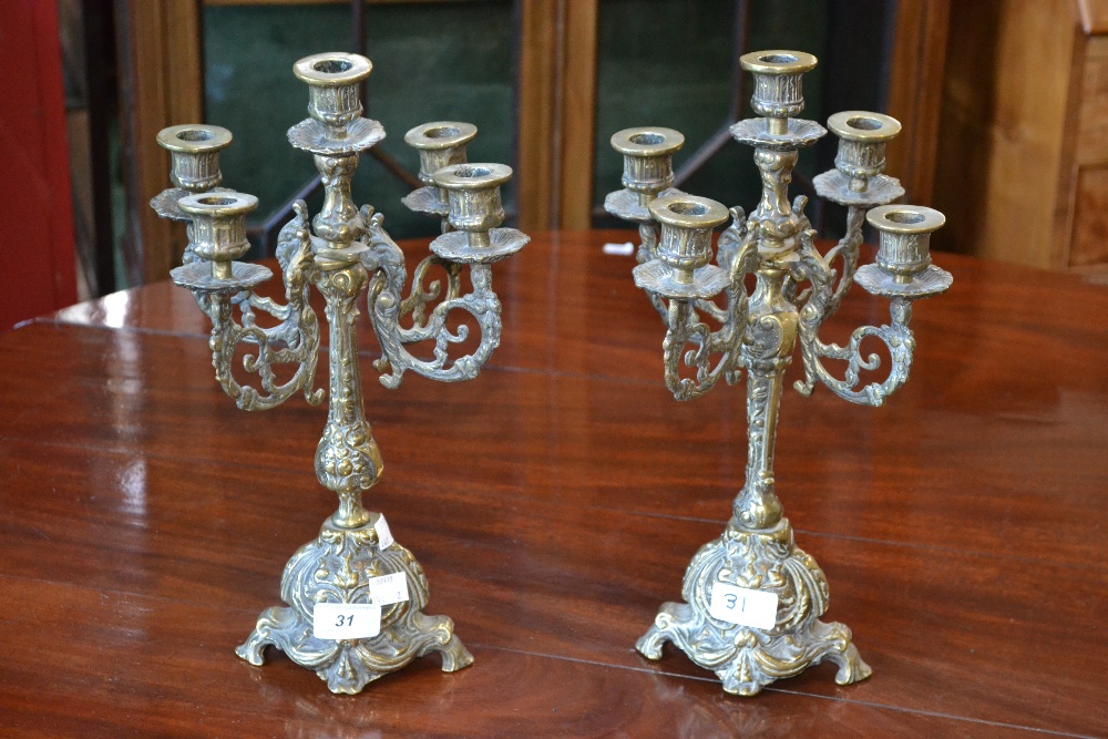 A pair of decorative brass candle sticks