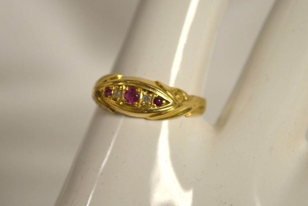 An 18ct gold ring set with ruby and diamond chips, 2g